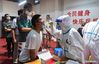 A health worker collects nucleic acid sample from a resident for COVID-19 test at a community in Jiangning District of Nanjing, capital of east China's Jiangsu Province, July 24, 2021. A second round of COVID-19 nucleic acid test was launched Saturday in Jiangning District of Nanjing. The eastern Chinese city on Friday reported 12 new locally transmitted COVID-19 cases and four asymptomatic ones, local health authorities said on Saturday. (Xinhua/Ji Chunpeng)