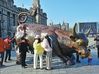 Visitors touch a bull sculpture in hopes of a better market during the Spring Festival holiday in Shanghai on Feb 16, 2021. [Photo/China Daily]