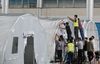 Staff members build a “Falcon” air-inflated testing lab for COVID-19 nucleic acid testing at the Yangzhou International Exhibition Center in Yangzhou, East China's Jiangsu province, on Aug 10, 2021. [Photo by Meng Delong/for China Daily]
In order to enhance its nucleic acid testing capacity, Yangzhou, East China's Jiangsu province, is building two “Falcon”air-inflated testing labs at the Yangzhou International Exhibition Center. The labs, capable of automatic COVID-19 tests, can screen up to 1.5 million people every day using the mixed testing approach of 10 in one.