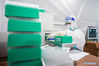 A medical worker operates at a 