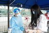 A staff member checks a passenger's identity information and health code at Nanjing Railway Station in Nanjing, capital of east China's Jiangsu Province, Aug. 23, 2021. Nanjing, which witnessed the country's latest resurgence of coronavirus cluster infections attributable to the Delta variant, cleared all medium- and high-risk areas for COVID-19 on Aug. 19. From Aug. 23, people leaving Nanjing by rail, highway, waterway, etc. will no longer be required to provide negative nucleic acid test certificates. (Xinhua/Ji Chunpeng)