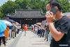 Citizens wait in line at a nucleic acid testing point in Yangzhou, east China's Jiangsu Province, Aug. 7, 2021. Yangzhou now has one high-risk area and 75 medium-risk areas for COVID-19, and the city authorities have strengthened the prevention and control measures to halt the spread of the coronavirus. (Xinhua/Li Bo)
