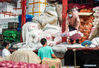 Merchants transport vegetables at a wholesale market in Yangzhou, east China's Jiangsu Province, Aug. 4, 2021. Yangzhou now has one high-risk area and 75 medium-risk areas for COVID-19, and the city authorities have strengthened the prevention and control measures to halt the spread of the coronavirus. (Xinhua/Li Bo)