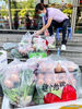 A community worker packs necessities for residents at a community in Guangling District in Yangzhou, east China's Jiangsu Province, Aug. 8, 2021. Yangzhou now has one high-risk area and 75 medium-risk areas for COVID-19, and the city authorities have strengthened the prevention and control measures to halt the spread of the coronavirus. (Xinhua/Li Bo)