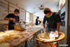 Staff members prepare meals for the senior citizens at the kitchen of Wenfeng Community in Guangling District of Yangzhou, east China's Jiangsu Province, Aug. 6, 2021. Yangzhou now has one high-risk area and 75 medium-risk areas for COVID-19, and the city authorities have strengthened the prevention and control measures to halt the spread of the coronavirus. (Xinhua/Li Bo)