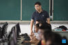 Yang Sen gives a computer class at Heping Primary School in Hefei City, east China's Anhui Province, Sept. 8, 2021. Yang Sen, a computer teacher from Heping Primary School, has interest in graphical language applied to robots in his spare time. After class, he organizes a robot club instructing his students to explore the use of multiple sensors and various scientific principles. (Xinhua/Zhou Mu)