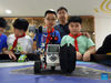 Yang Sen (R2) instructs his students at the robot club at Heping Primary School in Hefei City, east China's Anhui Province, Sept. 8, 2021. Yang Sen, a computer teacher from Heping Primary School, has interest in graphical language applied to robots in his spare time. After class, he organizes a robot club instructing his students to explore the use of multiple sensors and various scientific principles. (Xinhua/Zhou Mu)