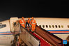 Astronaut Liu Boming waves to the crowd on his arrival in Beijing, capital of China, Sept. 17, 2021. Three Chinese astronauts, the first sent to orbit for space station construction, have completed their three-month mission and returned to Earth safely on Friday. They arrived in Beijing by plane Friday night. (Photo by Guo Zhongzheng/Xinhua)