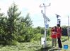 Bai Jie (R) and Li Ziyue, college students from China Agricultural University, check a small weather station in Future Orchard in Xiying Village of Yukou Township in Pinggu District of Beijing, capital of China, Aug. 25, 2021. 