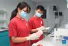 Bai Jie (L) and Zhou Zhan, college students from China Agricultural University, conduct experiment of measuring vitamin C content in peach at a lab in Future Orchard in Xiying Village of Yukou Township in Pinggu District of Beijing, capital of China, Sept. 14, 2021. 