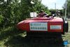 Lin Guihai, a college students from China Agricultural University, checks an autopilot sprayer in Future Orchard in Xiying Village of Yukou Township in Pinggu District of Beijing, capital of China, Aug. 25, 2021. 