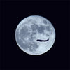 An airplane flies against the backdrop of a full moon in Chongqing municipality on Sept 21, 2021. [Photo/IC]