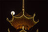 A full moon is seen behind a tower in Congjiang, Guizhou province, on Sept 21, 2021. [Photo/IC]