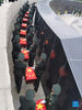 Photo taken with a mobile phone shows coffins containing the remains of Chinese People's Volunteers (CPV) martyrs escorted by soldiers during a burial ceremony at the CPV martyrs' cemetery in Shenyang, northeast China's Liaoning Province, Sept. 3, 2021. The remains of 109 Chinese soldiers killed in the 1950-53 Korean War were laid to rest on Friday in Shenyang. (Xinhua/Yang Qing)