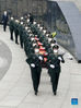 Photo taken with a mobile phone shows coffins containing the remains of Chinese People's Volunteers (CPV) martyrs escorted by soldiers during a burial ceremony at the CPV martyrs' cemetery in Shenyang, northeast China's Liaoning Province, Sept. 3, 2021. The remains of 109 Chinese soldiers killed in the 1950-53 Korean War were laid to rest on Friday in Shenyang. (Xinhua/Yang Qing)