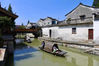 Performers in Han-style costumes perform on boats in a riverlet at Yigao village in Huzhou, East China's Zhejiang province, on July 14, 2021. [Photo by Zhu Xingxin/chinadaily.com.cn]