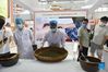 A staff member demonstrates the process of making Traditional Chinese Medicine (TCM) at the Health Services exhibition area during the 2021 China International Fair for Trade in Services (CIFTIS) held in Beijing, capital of China, Sept. 3, 2021. (Xinhua/Lu Peng)