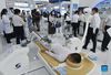 Visitors view a massaging robot at the Health Services exhibition area during the 2021 China International Fair for Trade in Services (CIFTIS) held in Beijing, capital of China, Sept. 3, 2021. (Xinhua/Lu Peng)