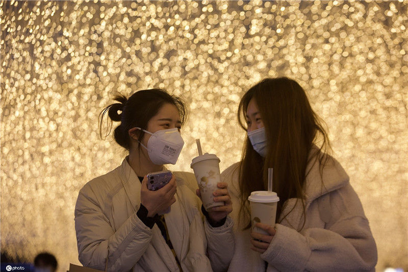 楚河汉街,灯光下,两名女孩拿着奶茶.郑新洽/xjb/ic photo