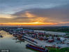 2022年8月5日，江苏淮安，夕阳映照下的港口物流集团新港码头及大运河运输一片繁忙。