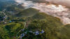 2023年9月15日，重庆市，酉阳土家族苗族自治县丁市镇大龙村，群山逶迤，轻纱似的雾气在山涧流淌，日出、山道、村落、开始发黄的小树组成一幅幅美丽的乡村美景。