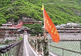 近日，四川省泸定县东说念主武部组织民兵重走长征路。图为队列行进在泸定桥上。张  政摄